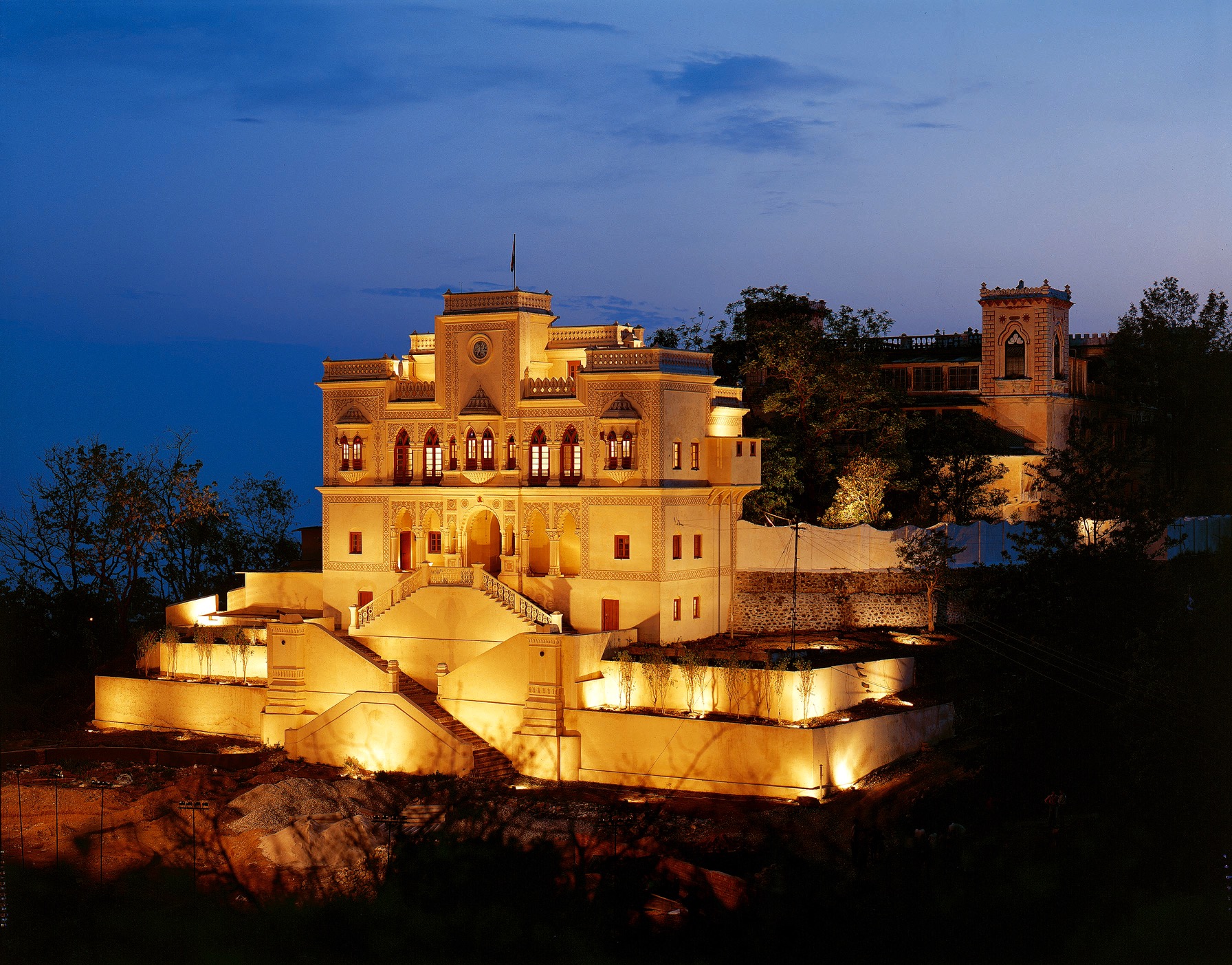 The Maharaja building of Ananda in the Himalaya in India, at sunset, with beautiful lightning on the facade