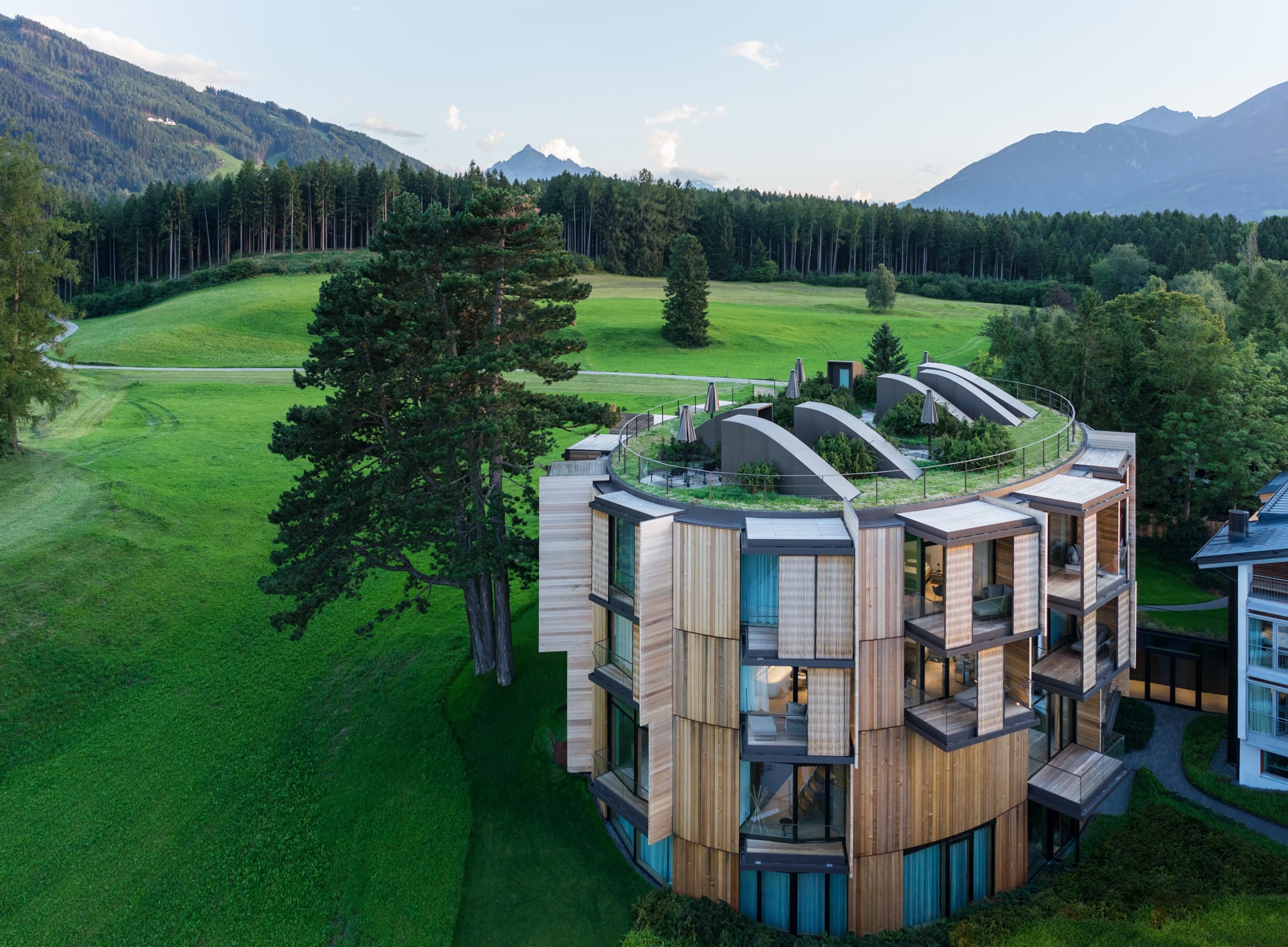 Aerial view of Lanserhof Lans, with meadows, forests and mountains in the background