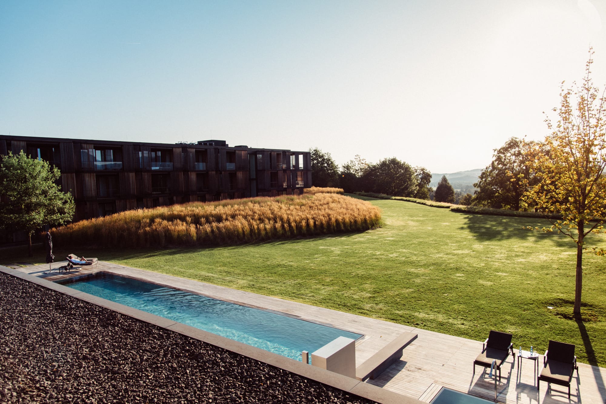 View from the rooftop over the swimming pool at Lanserhof Tegernsee and the surrounding nature