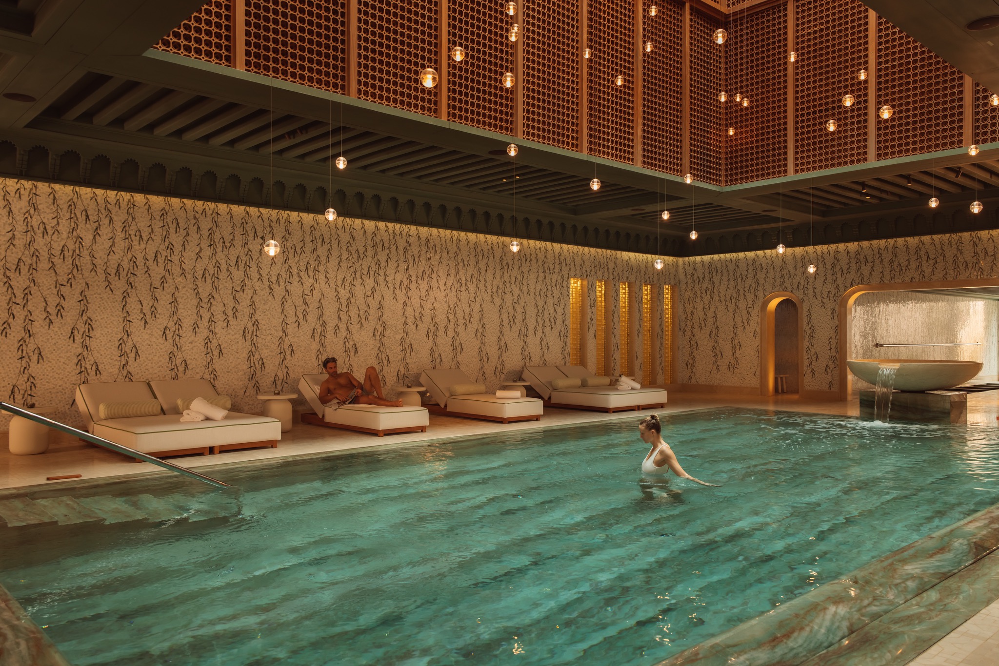 A female guest standing in the vitality pool at Royal Mansour Tamuday Bay during a longevity program