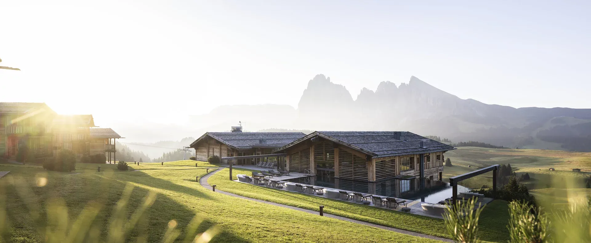 Panoramic view of Adler Lodge Alpe set against the Dolomites landscape on Alpe di Siusi