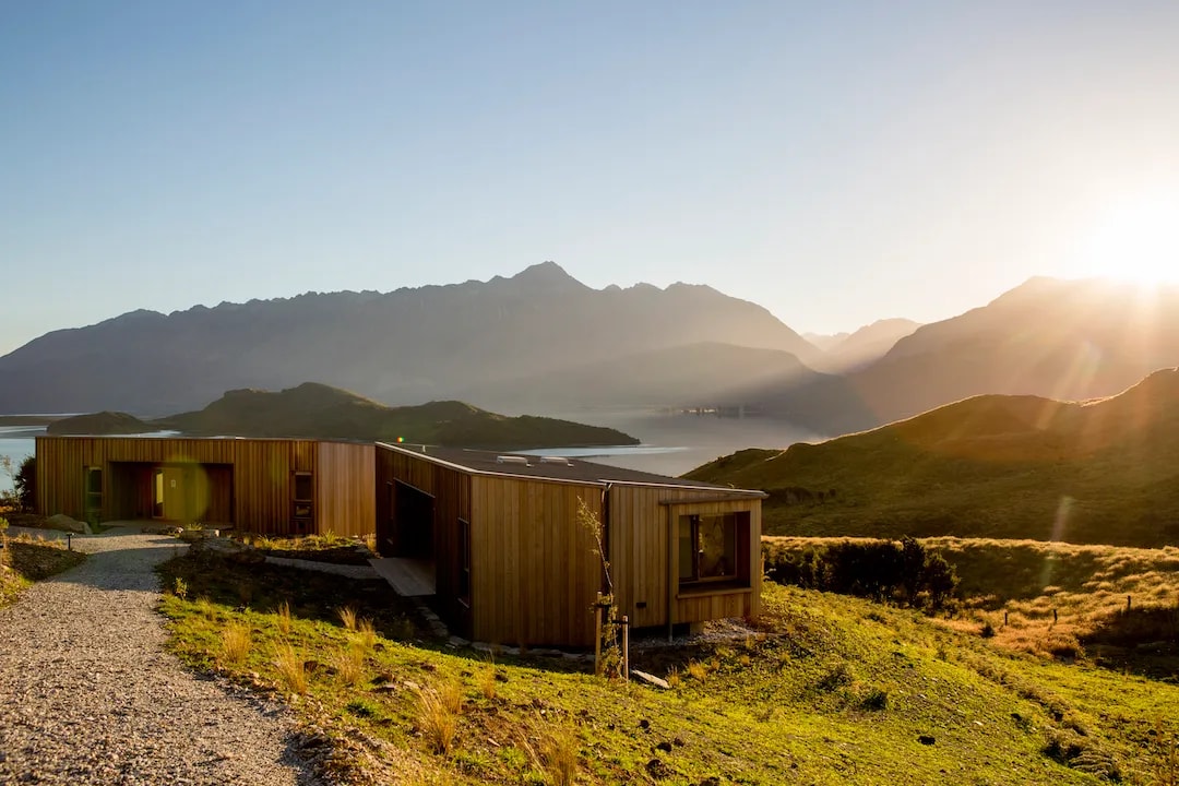 The Passivhaus pavilions of Aro Hā Wellness Retreat above Lake Wakatipu at sunrise