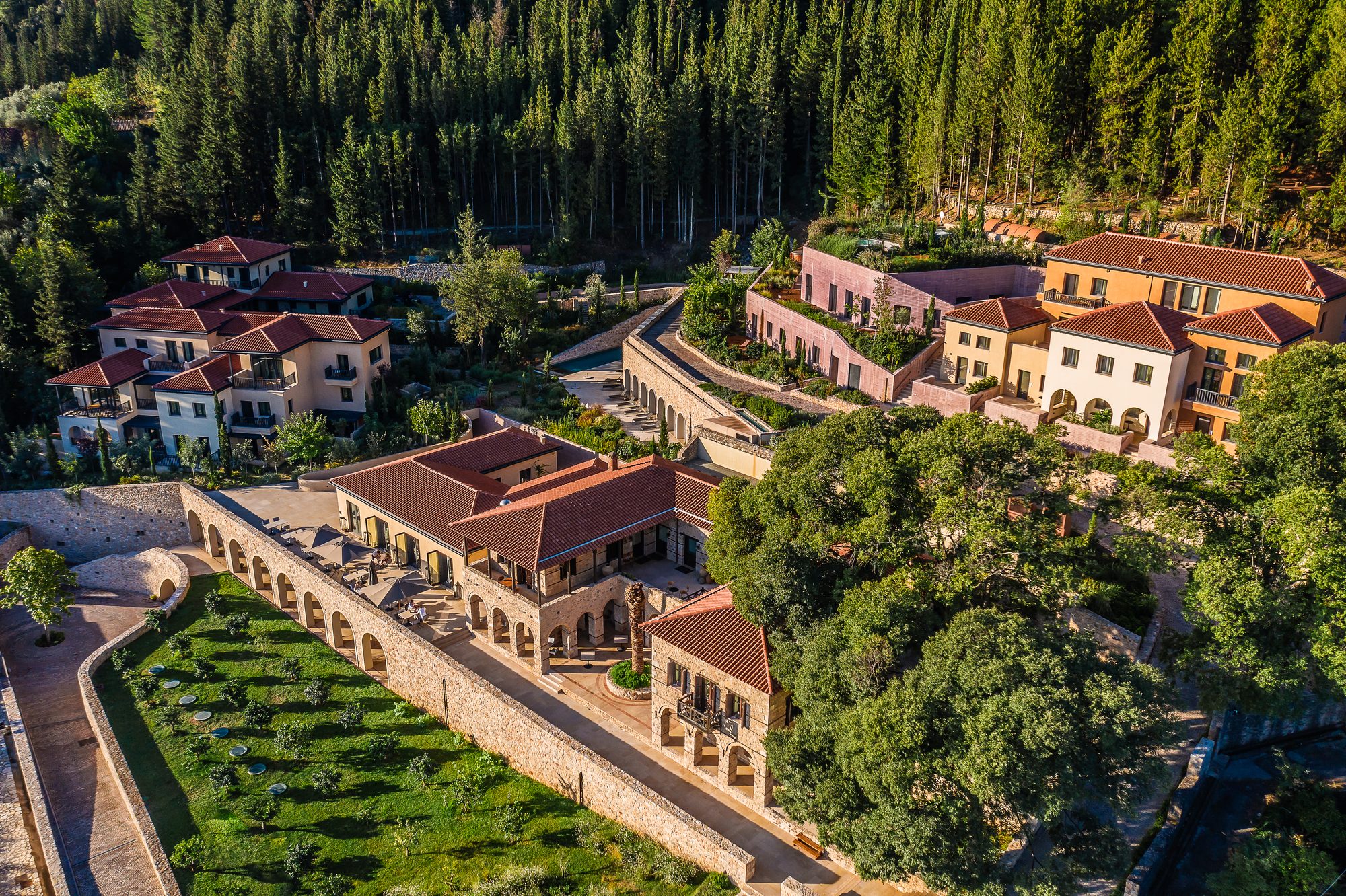 Aerial drone view of Euphoria Retreat above the medieval village of Mystras, luxury wellness retreat Peloponnese Greece